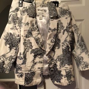 A skirt suit with silver/grey flowers all over.